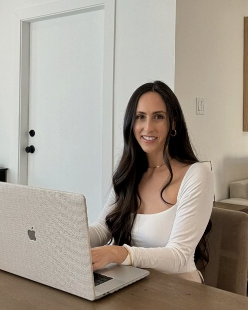 Ali, educational therapist, smiling at her desk
