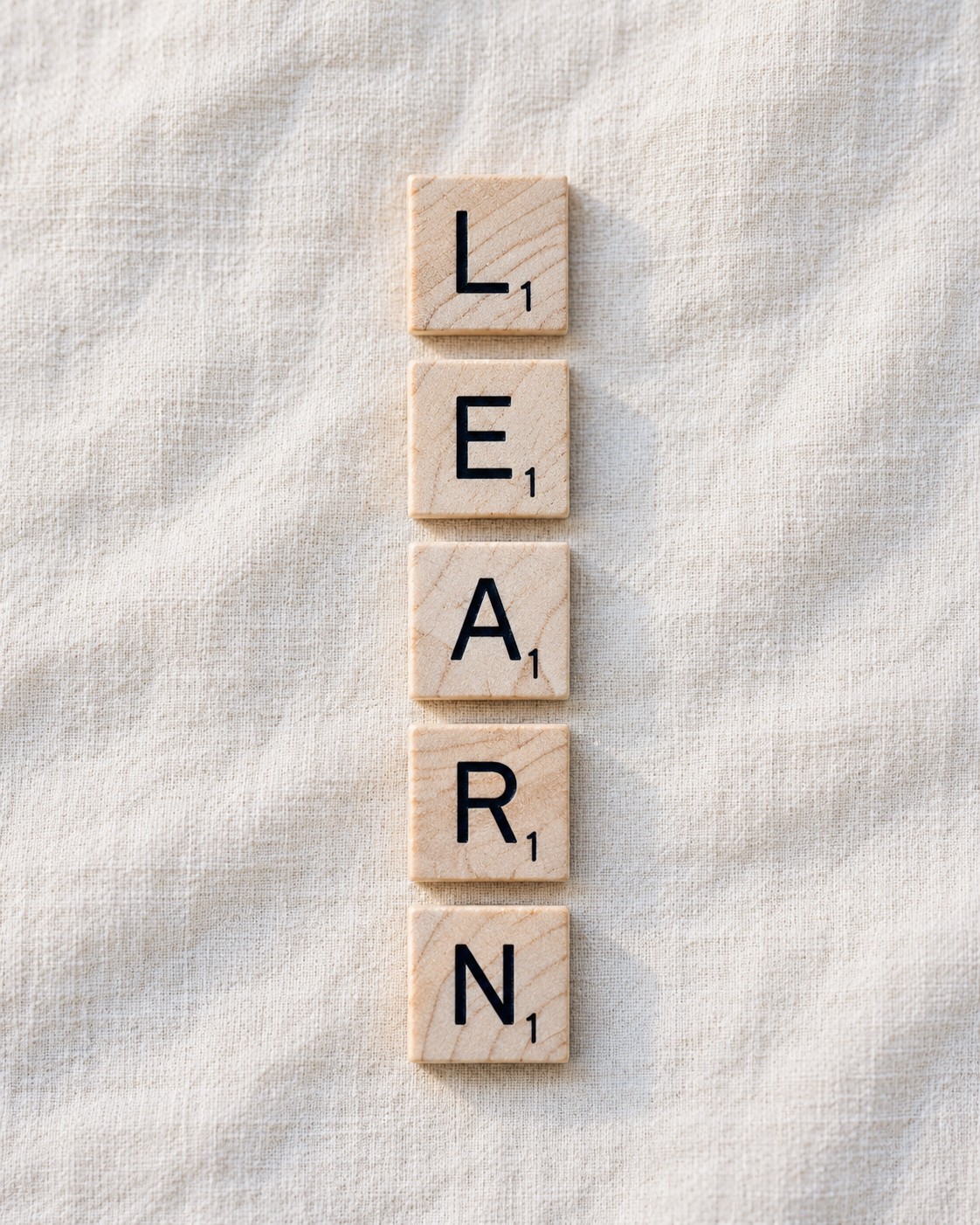 Wooden letter tiles spelling LEARN
